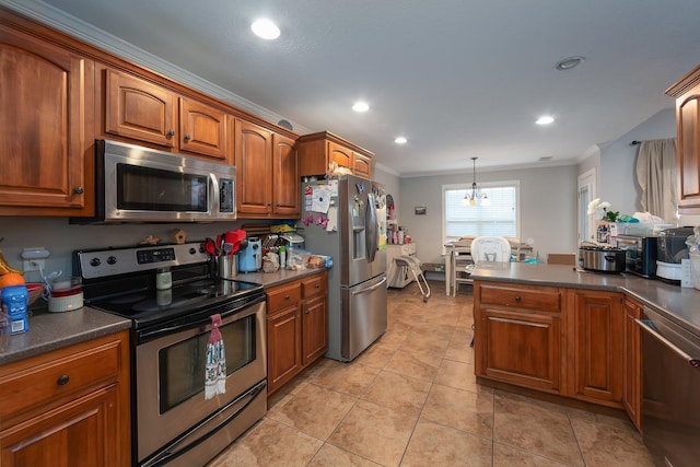 kitchen with pendant lighting, ornamental molding, stainless steel appliances, and a chandelier