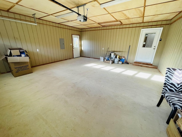 garage featuring electric panel and a garage door opener