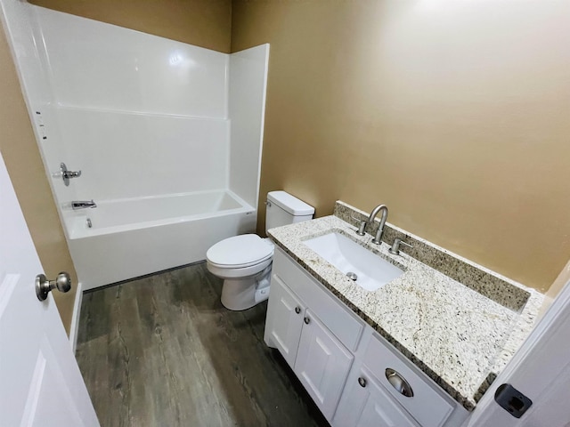 full bathroom featuring shower / washtub combination, vanity, wood-type flooring, and toilet