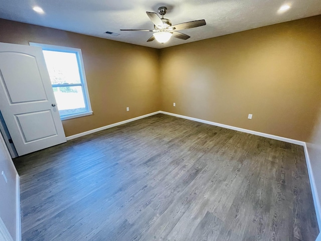 empty room with ceiling fan and hardwood / wood-style flooring