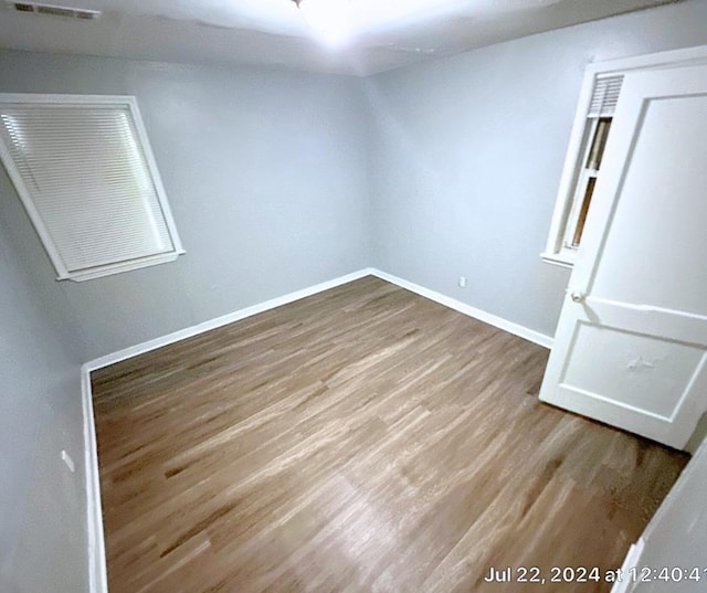 empty room with hardwood / wood-style floors