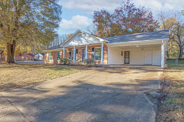 ranch-style house featuring a front yard and a carport