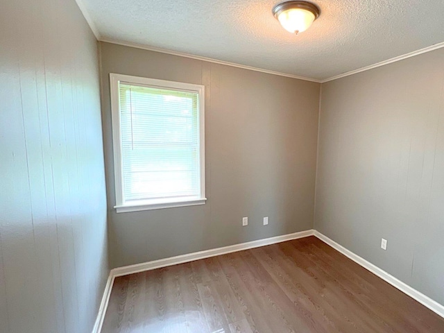 unfurnished room with hardwood / wood-style flooring, crown molding, and a textured ceiling