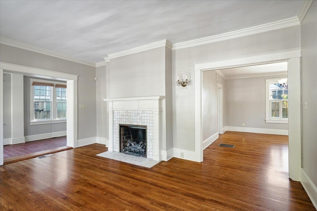 unfurnished living room featuring a wealth of natural light, crown molding, and dark wood-type flooring