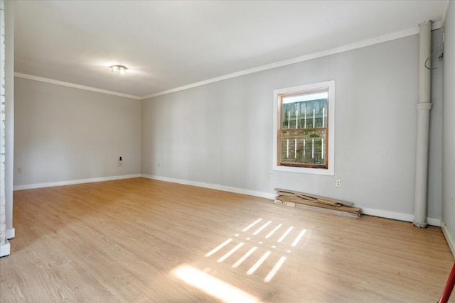 spare room with light hardwood / wood-style floors and ornamental molding