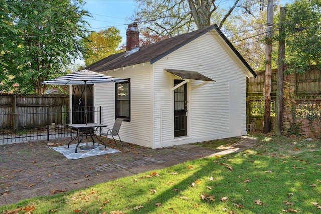 back of property with a patio and a lawn