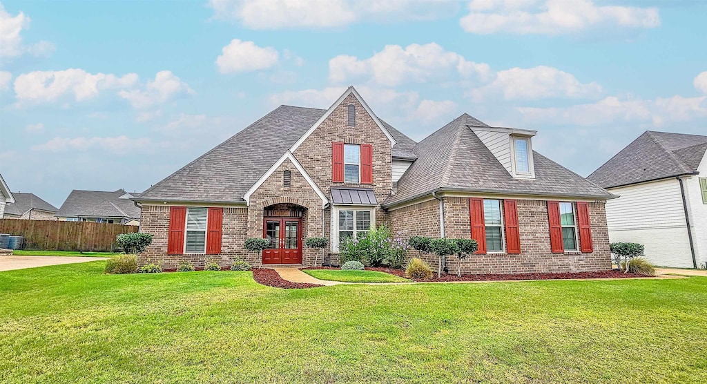 view of front of home with french doors and a front yard