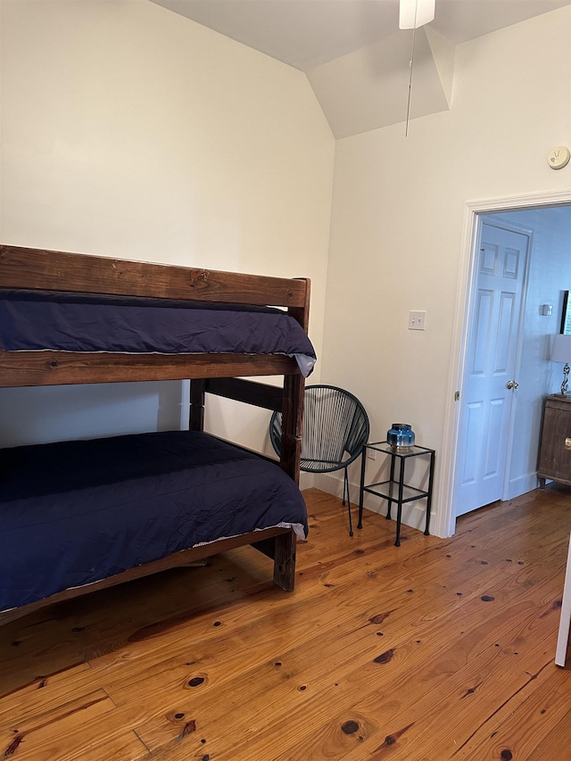 bedroom featuring wood-type flooring and vaulted ceiling