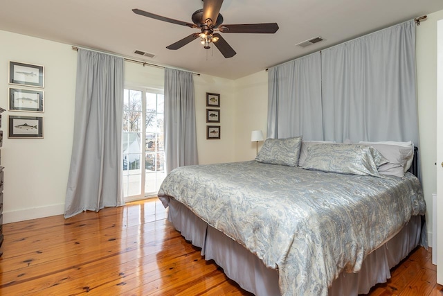 bedroom with access to outside, ceiling fan, and hardwood / wood-style floors