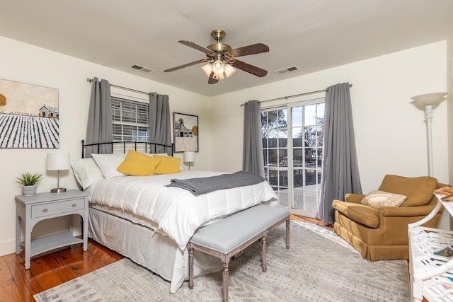 bedroom featuring hardwood / wood-style floors, ceiling fan, and access to outside