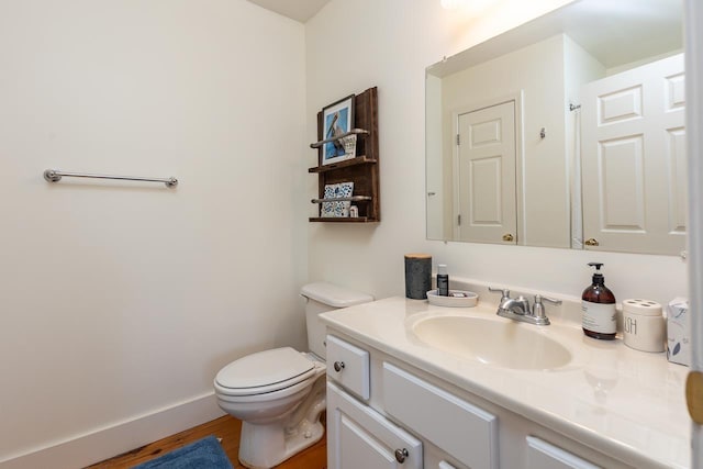 bathroom featuring vanity, toilet, and wood-type flooring