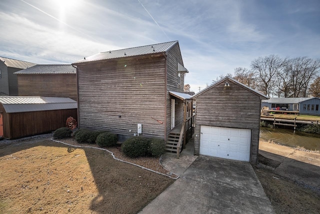 view of home's exterior featuring a garage and an outbuilding