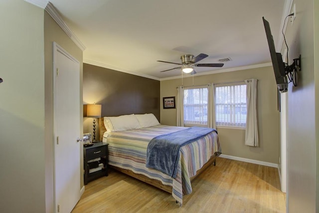 bedroom featuring ceiling fan, light hardwood / wood-style flooring, and crown molding