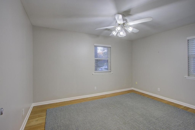 spare room featuring wood-type flooring and ceiling fan