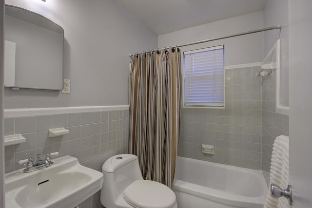 full bathroom featuring shower / bath combo, toilet, tile walls, and sink