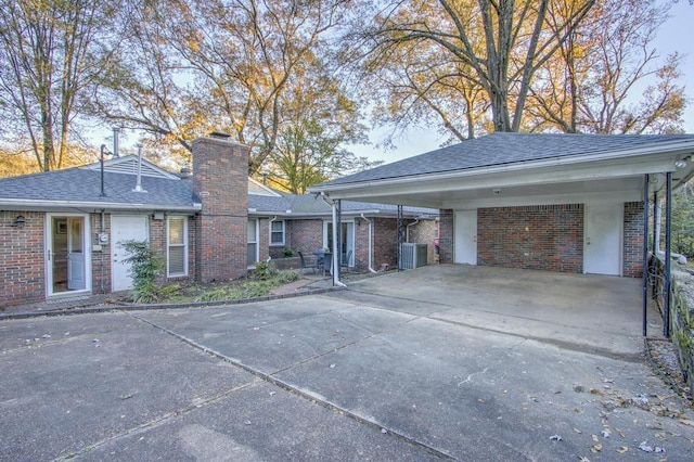 view of front of home with cooling unit and a carport