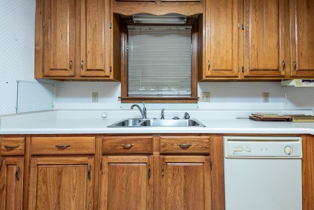 kitchen featuring wallpapered walls, brown cabinetry, dishwasher, light countertops, and a sink