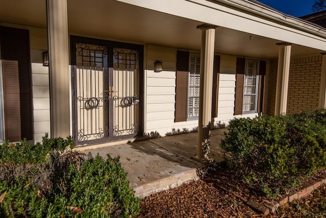 entrance to property featuring brick siding