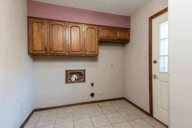 washroom featuring washer hookup, cabinet space, electric dryer hookup, and baseboards