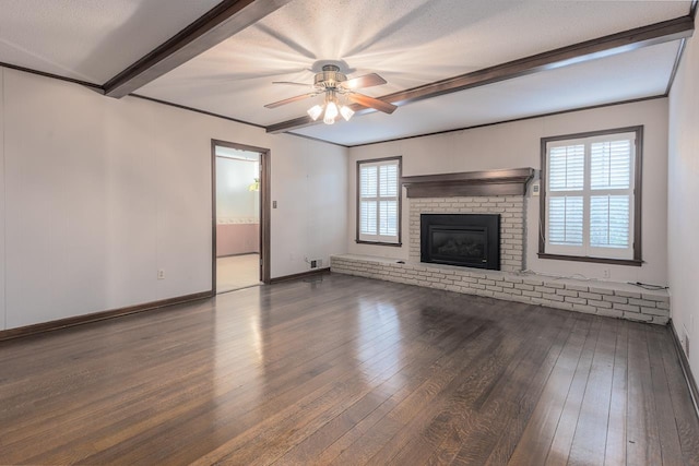 unfurnished living room with a ceiling fan, a brick fireplace, wood finished floors, beamed ceiling, and baseboards