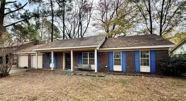 ranch-style house featuring a porch and a garage