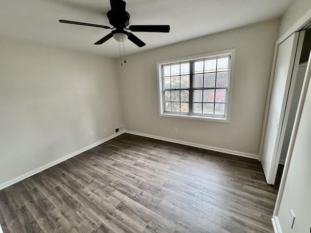 unfurnished bedroom featuring ceiling fan and dark hardwood / wood-style floors