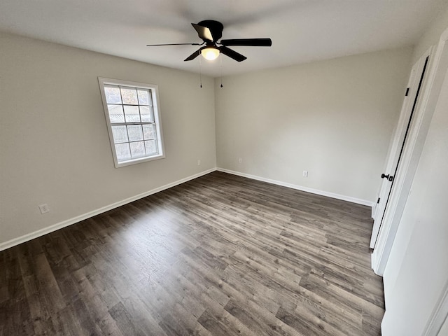 unfurnished room with dark hardwood / wood-style flooring and ceiling fan