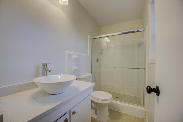 bathroom featuring vanity, toilet, and an enclosed shower