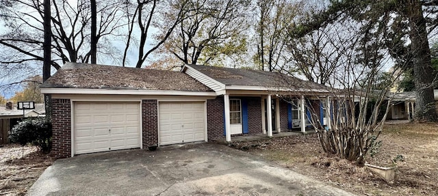 single story home with covered porch and a garage