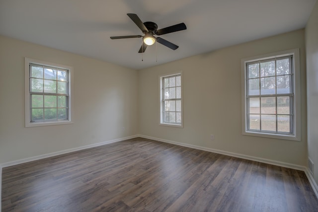 empty room featuring ceiling fan and dark hardwood / wood-style floors