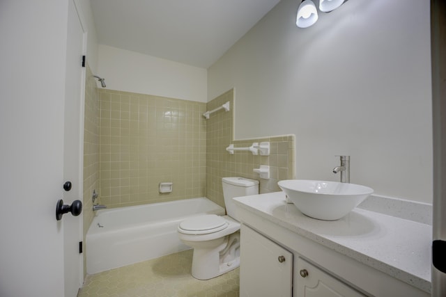 full bathroom with vanity, tiled shower / bath combo, toilet, and tile patterned flooring