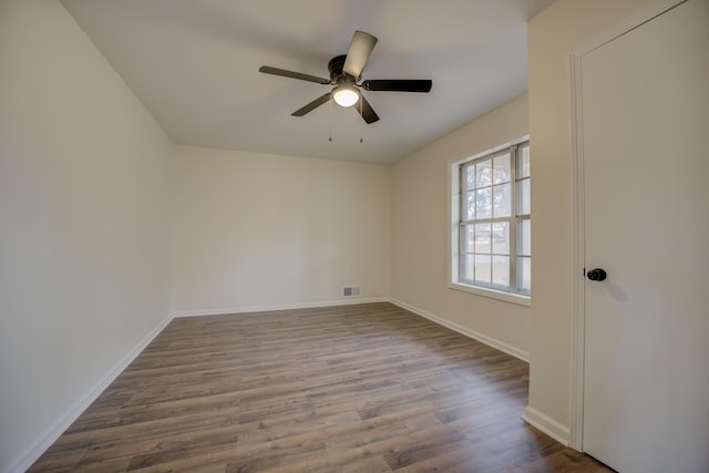 spare room featuring wood-type flooring and ceiling fan