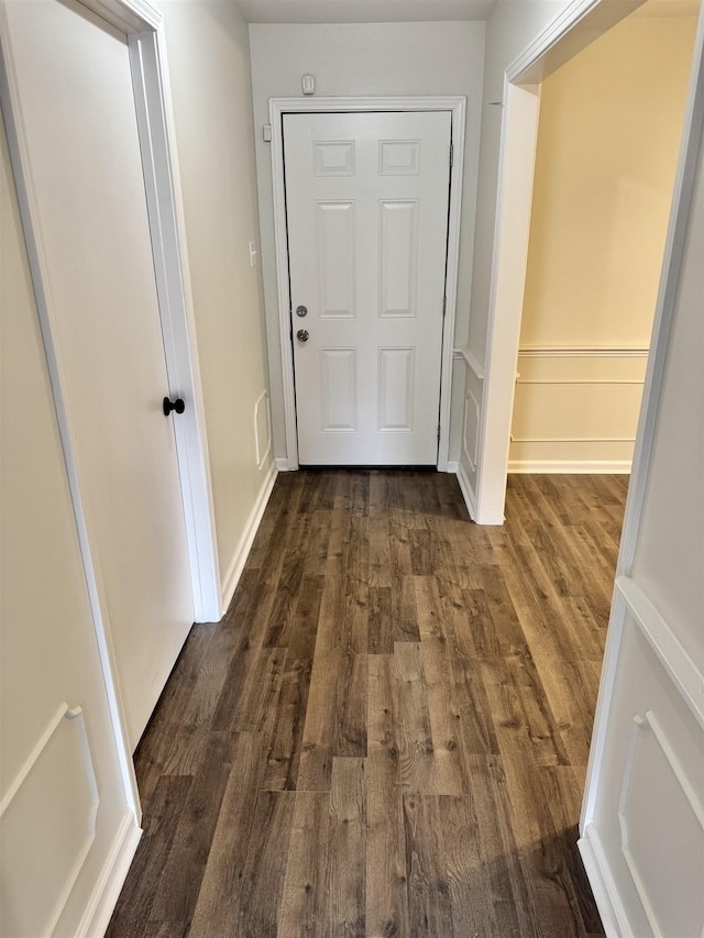 corridor with dark wood-type flooring