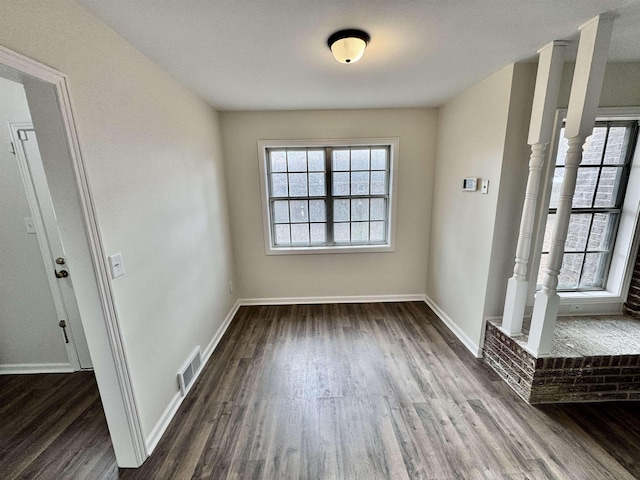 spare room with dark hardwood / wood-style flooring