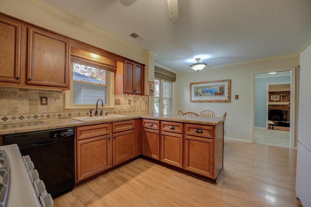 kitchen featuring kitchen peninsula, dishwasher, sink, and light hardwood / wood-style floors