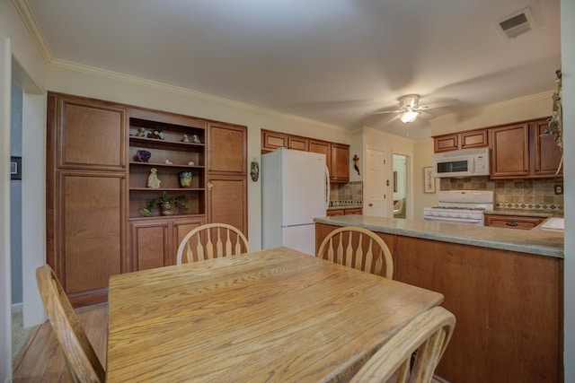 dining space featuring ceiling fan and ornamental molding