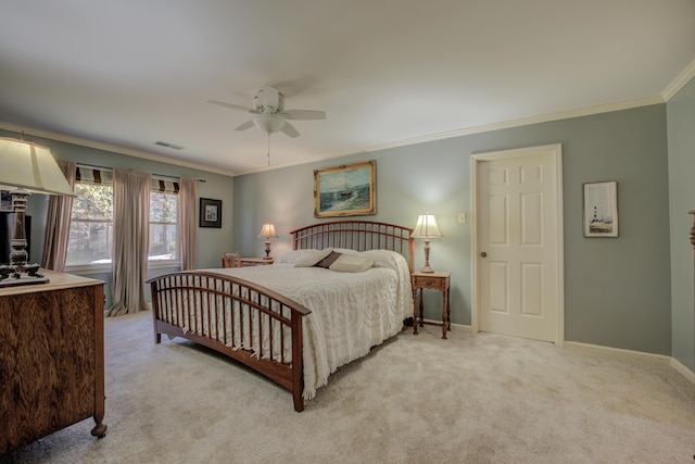 carpeted bedroom featuring ceiling fan and crown molding