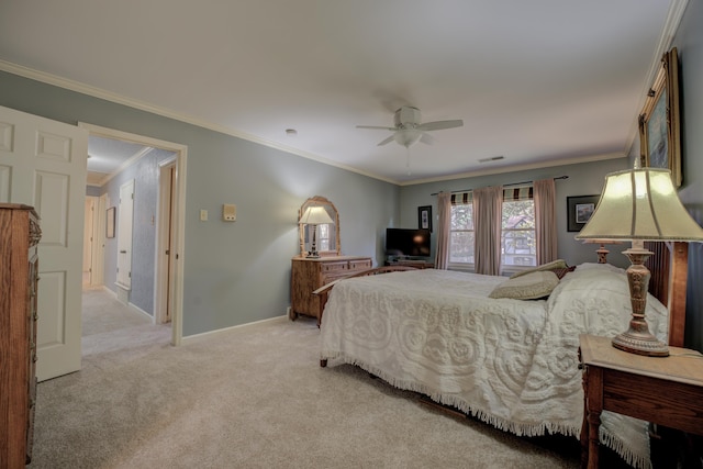 carpeted bedroom with ceiling fan and ornamental molding