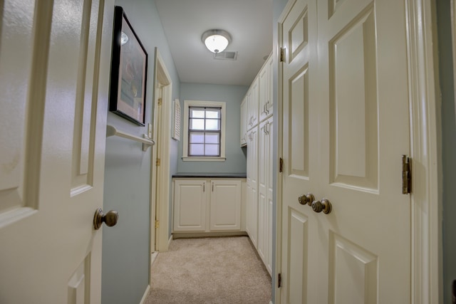 hallway with light colored carpet