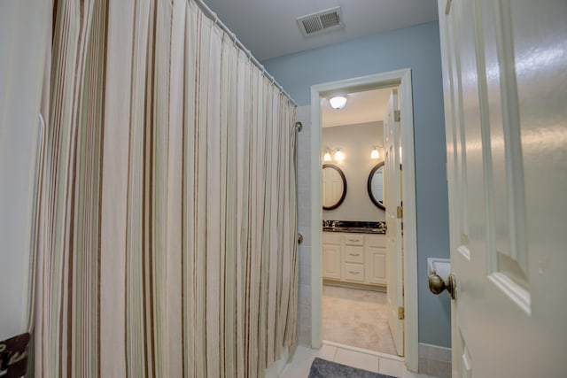 bathroom with tile patterned flooring and vanity