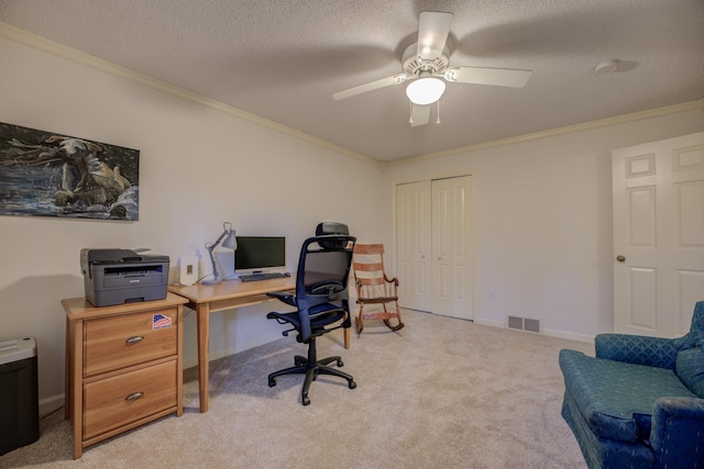 office featuring a textured ceiling, light colored carpet, ceiling fan, and crown molding