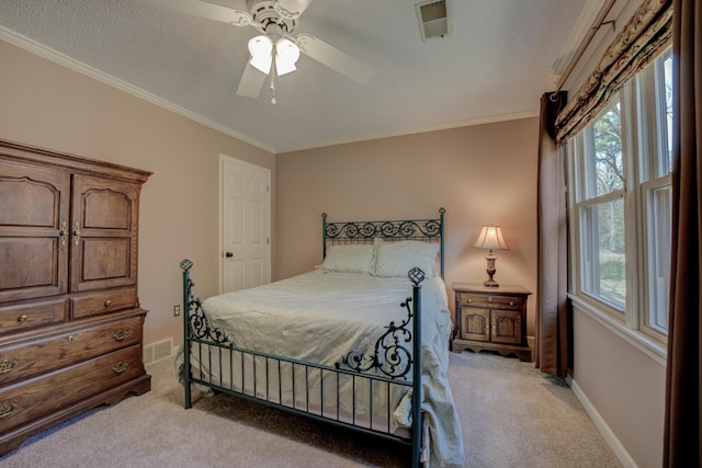 carpeted bedroom with a textured ceiling, ceiling fan, and ornamental molding