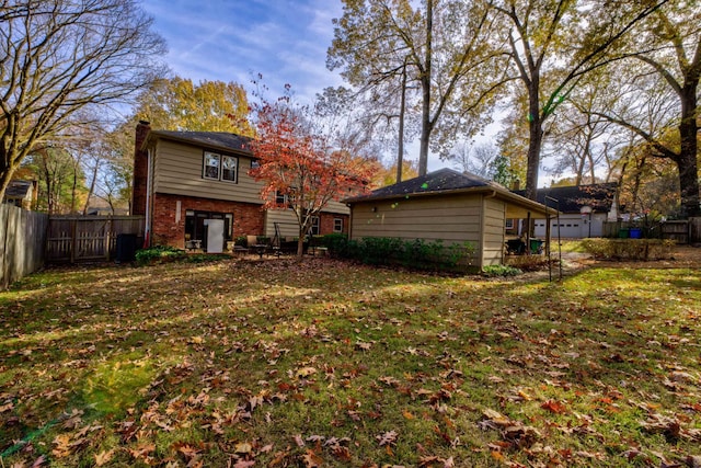 rear view of property with a yard