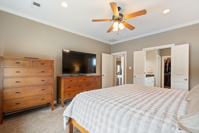 carpeted bedroom featuring crown molding, ceiling fan, a spacious closet, connected bathroom, and a closet