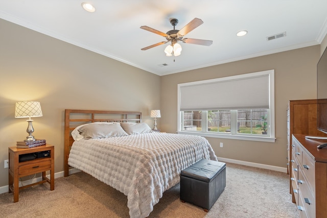 bedroom with ceiling fan, crown molding, and light colored carpet