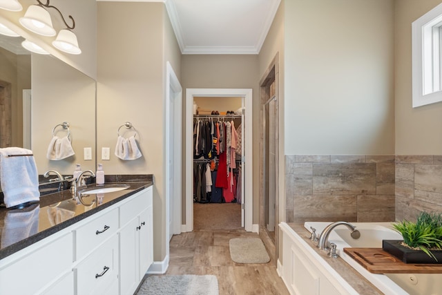 bathroom featuring vanity, independent shower and bath, and ornamental molding