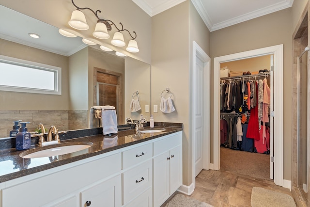 bathroom featuring vanity, an enclosed shower, and ornamental molding