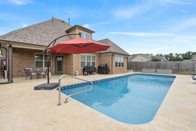 view of swimming pool with area for grilling and a patio area