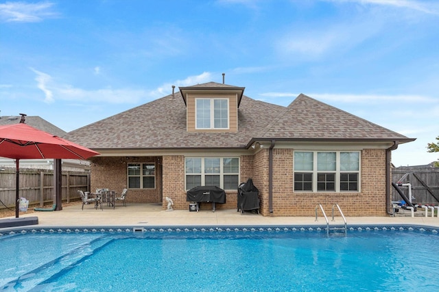 view of pool featuring a patio area and grilling area