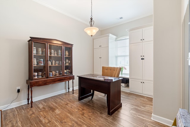 office area featuring hardwood / wood-style flooring and crown molding